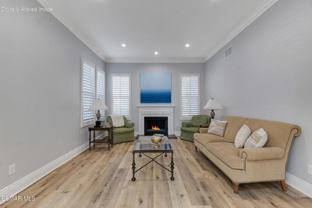 6140 Deerhill Road Oak Park, CA 91377 - Photo 19 of 72 a living room with furniture a fireplace and a wooden floor