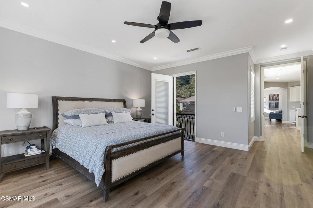 6140 Deerhill Road Oak Park, CA 91377 - Photo 25 of 72 a bedroom with a bed and wooden floor