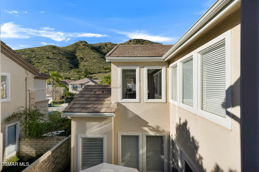 6140 Deerhill Road Oak Park, CA 91377 - Photo 27 of 72 a view of a white house next to a yard