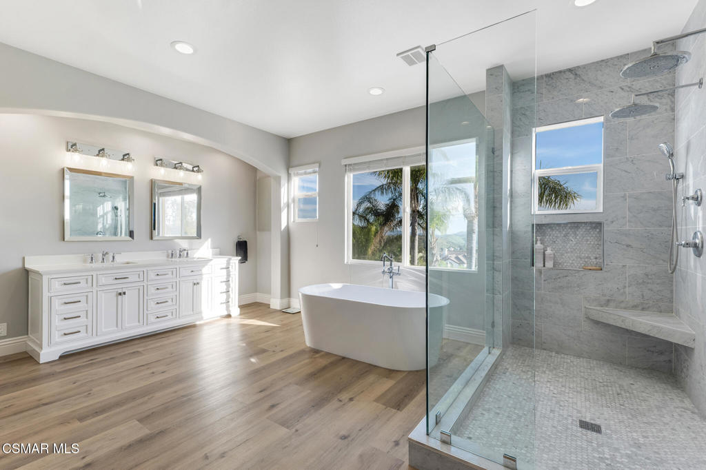 6140 Deerhill Road Oak Park, CA 91377 - Photo 28 of 72 a spacious bathroom with a double vanity sink a mirror and a shower