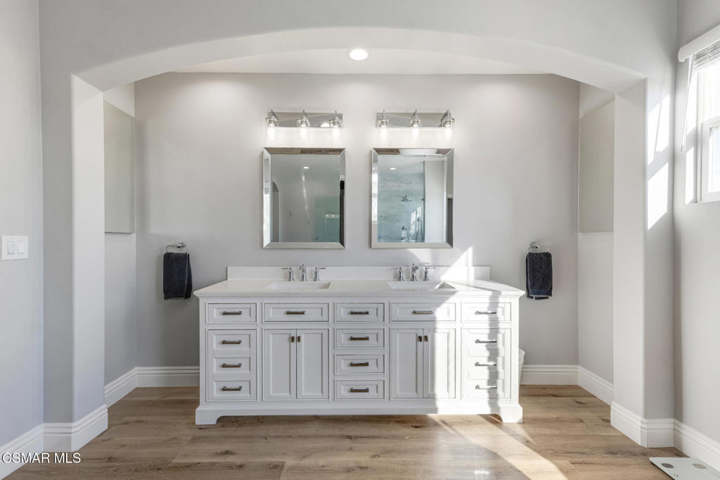 6140 Deerhill Road Oak Park, CA 91377 - Photo 29 of 72 a spacious bathroom with a double vanity sink and a mirror