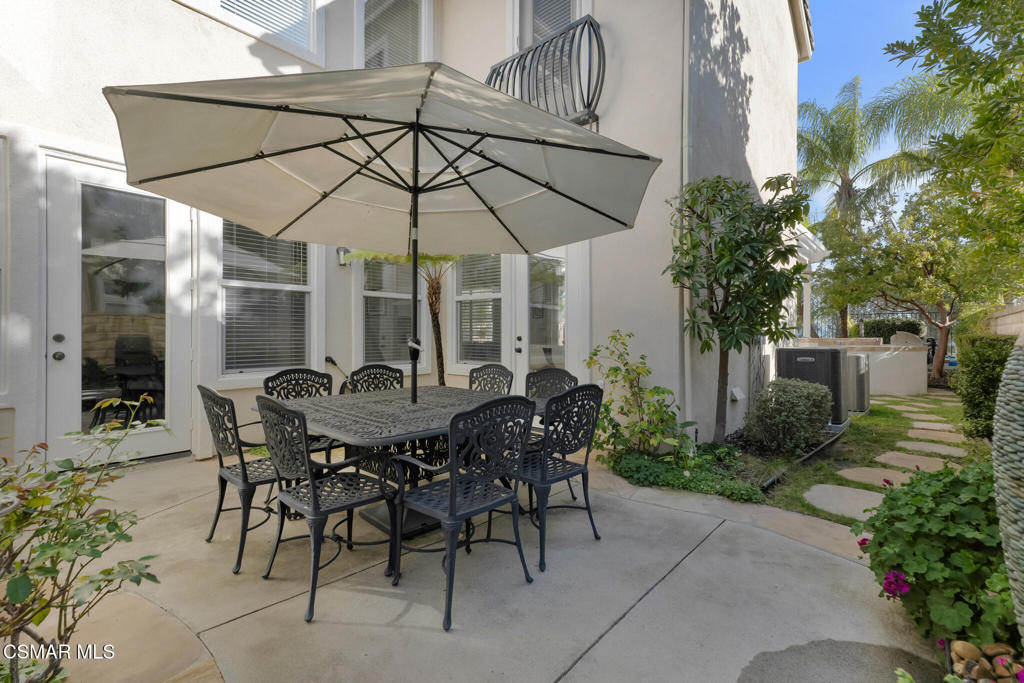 6140 Deerhill Road Oak Park, CA 91377 - Photo 33 of 72 a view of a patio with table and chairs under an umbrella