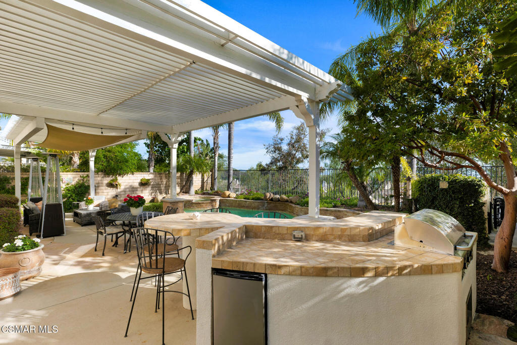 6140 Deerhill Road Oak Park, CA 91377 - Photo 34 of 72 a view of a patio with table and chairs under an umbrella