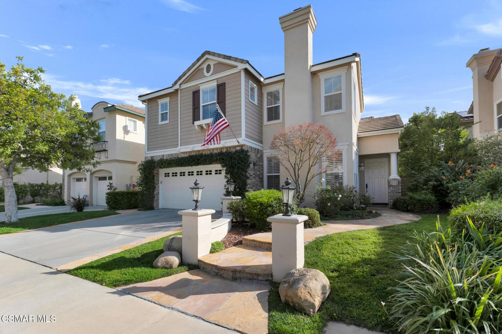 6140 Deerhill Road Oak Park, CA 91377 - Photo 4 of 72 a front view of a house with a yard and garage