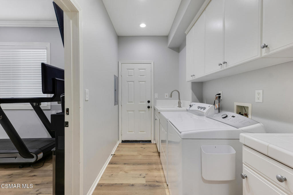 6140 Deerhill Road Oak Park, CA 91377 - Photo 41 of 72 a utility room with sink dryer and washer