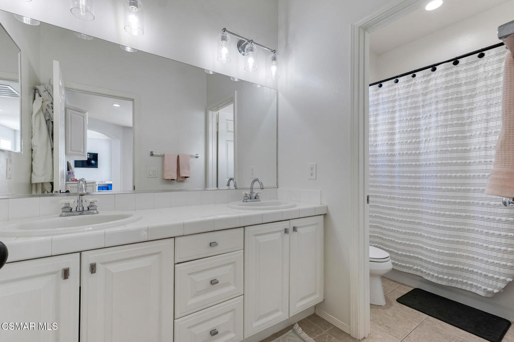 6140 Deerhill Road Oak Park, CA 91377 - Photo 45 of 72 a bathroom with a sink and a mirror