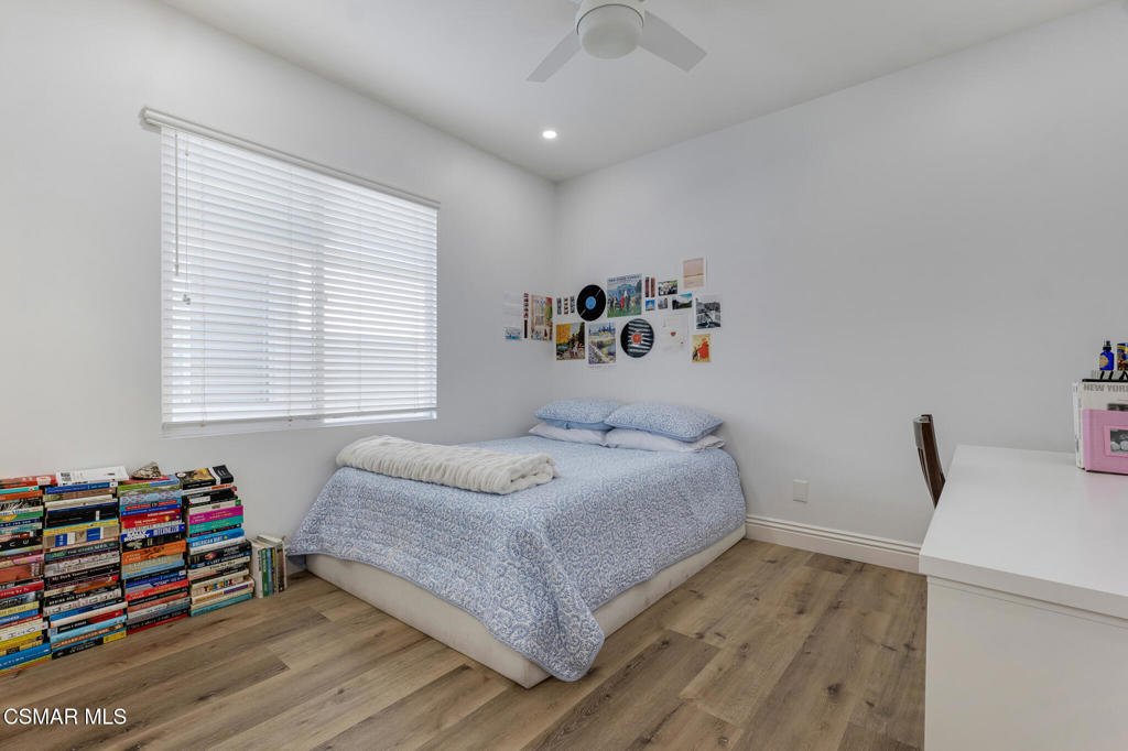 6140 Deerhill Road Oak Park, CA 91377 - Photo 46 of 72 a bedroom with a bed and a wooden floor