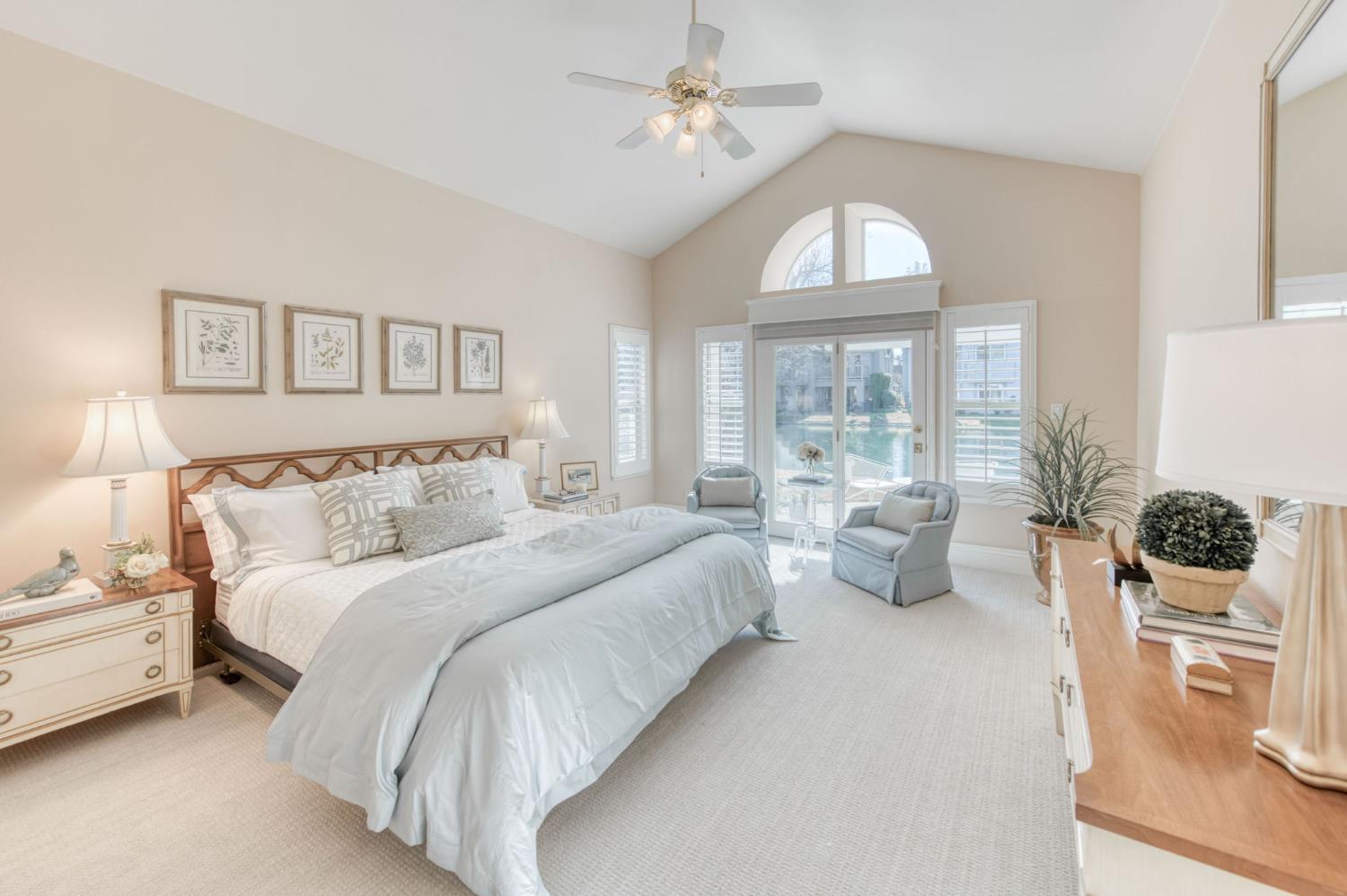 3063 West Pembrook Loop Fresno, CA 93711 - Photo 19 of 52 a spacious bedroom with a bed a chandelier and a large window