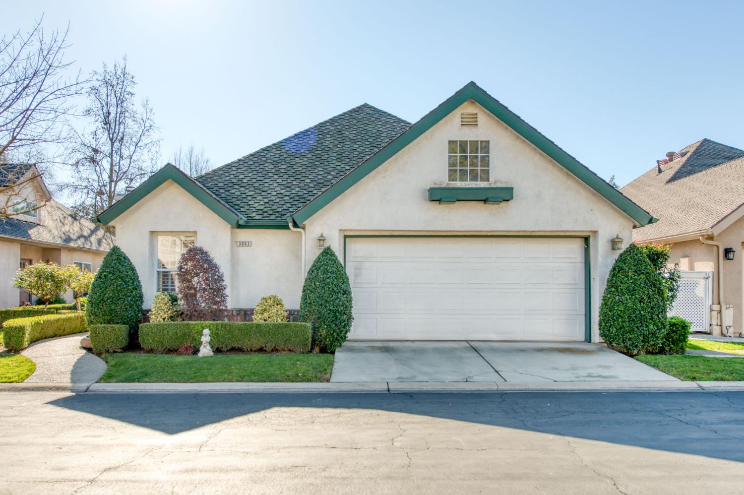 3063 West Pembrook Loop Fresno, CA 93711 - Photo 37 of 52 a front view of house with garage and green space