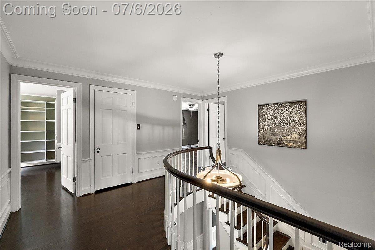 1051 Devonshire Road Grosse Pointe, MI 48230 - Photo 33 of 98 Upper-level hallway featuring dark wood-finish flooring, white paneled doors, and crown molding