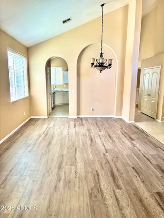 a view of a room with wooden floor and windows