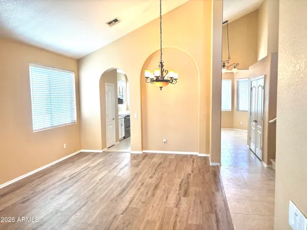 a view of a room with wooden floor