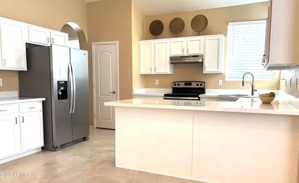 a kitchen with a sink and a refrigerator