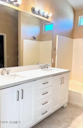 a bathroom with a sink vanity and mirror