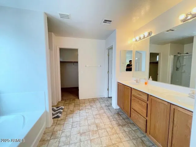 a large bathroom with a tub and shower