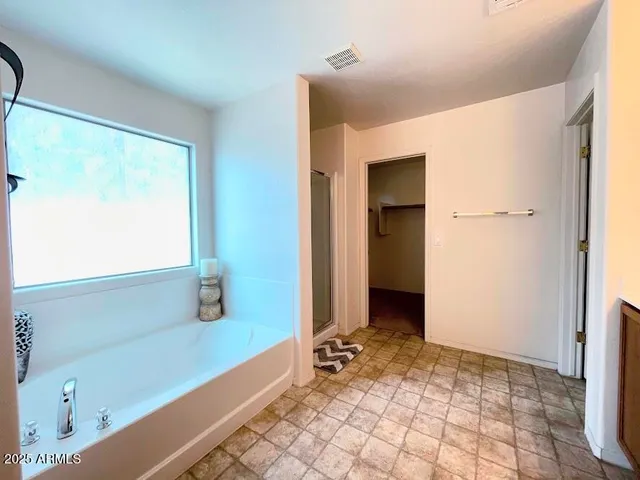 a view of a bathroom with a bathtub and a shower