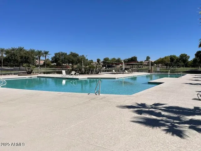 a view of a swimming pool and lounge chair
