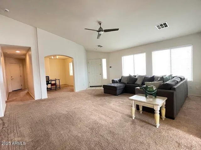 a living room with furniture and a chandelier