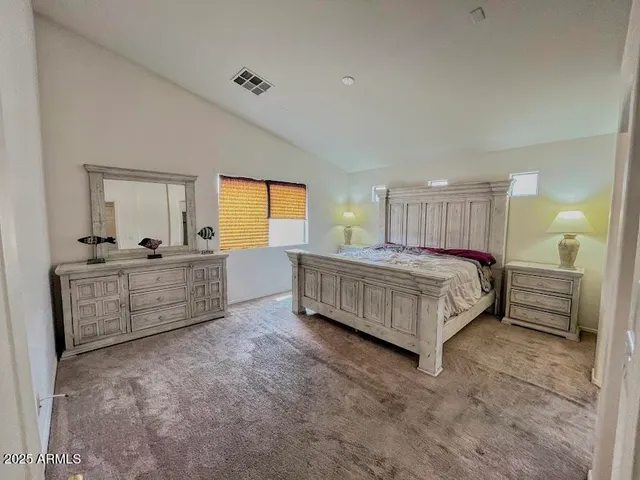 a bedroom with a bed and dresser