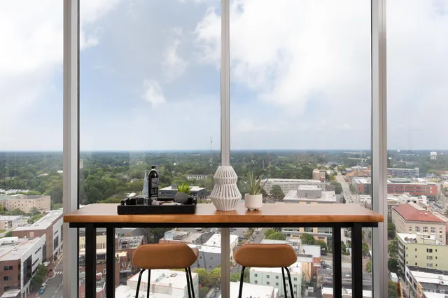 a dining room with furniture and window