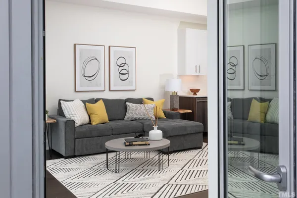 a living room with furniture and a glass door