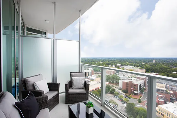a view of a balcony with furniture