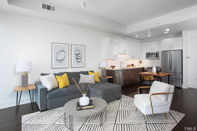 a living room with furniture and kitchen view