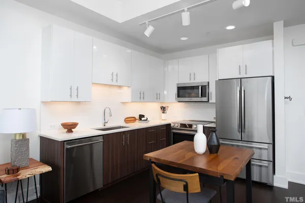 a kitchen with a sink a stove a refrigerator and cabinets