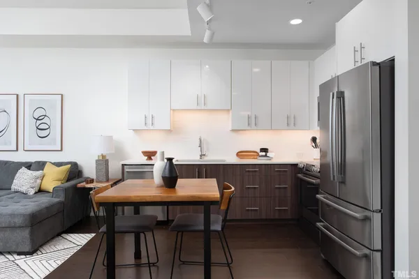 a kitchen with a refrigerator and wooden cabinets
