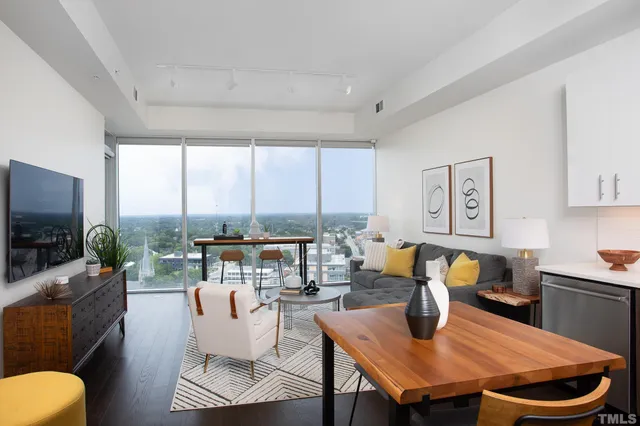 a living room with fireplace furniture and a flat screen tv