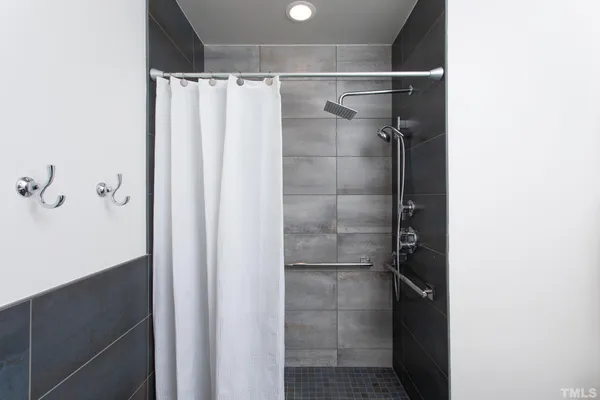 a bathroom with a glass shower door