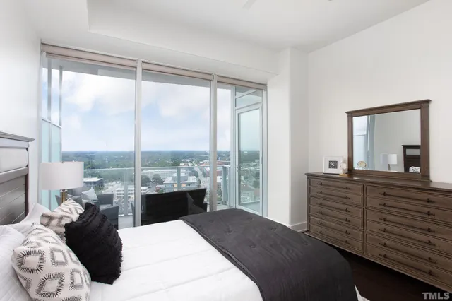 a bedroom with a large bed and a large window