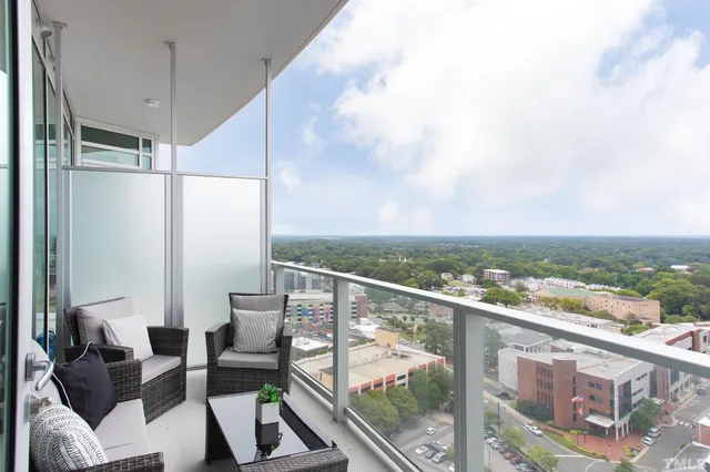 a view of a balcony with furniture