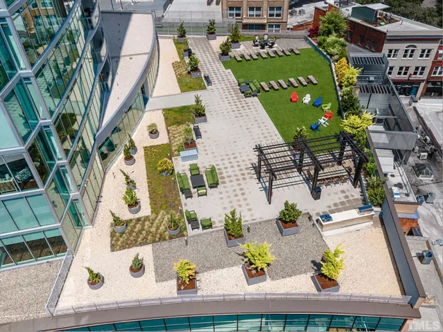 an aerial view of residential houses with outdoor space