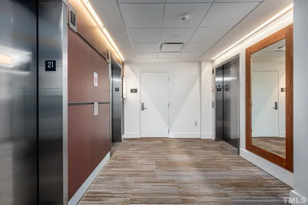 a view of hallway with wooden floor