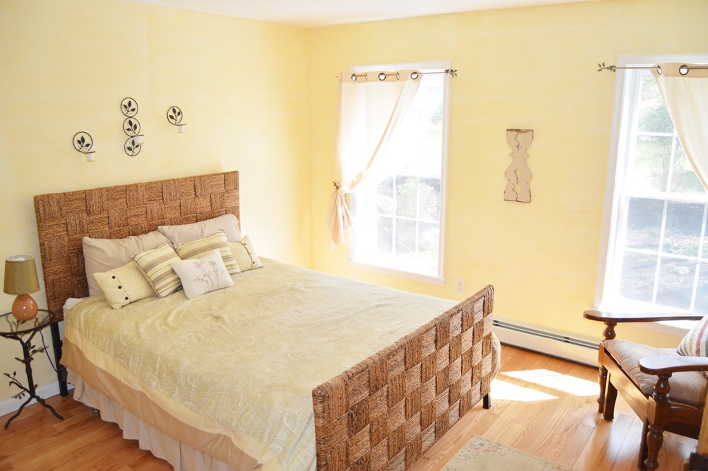 19 Birch Road Cumberland, RI 02864 - Photo 13 of 24 a bedroom with a bed and wooden floor