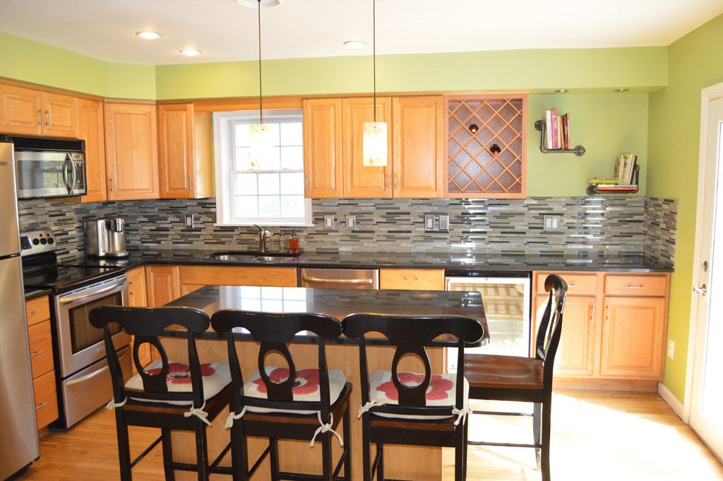 19 Birch Road Cumberland, RI 02864 - Photo 3 of 24 a view of a kitchen with granite countertop a table and chairs