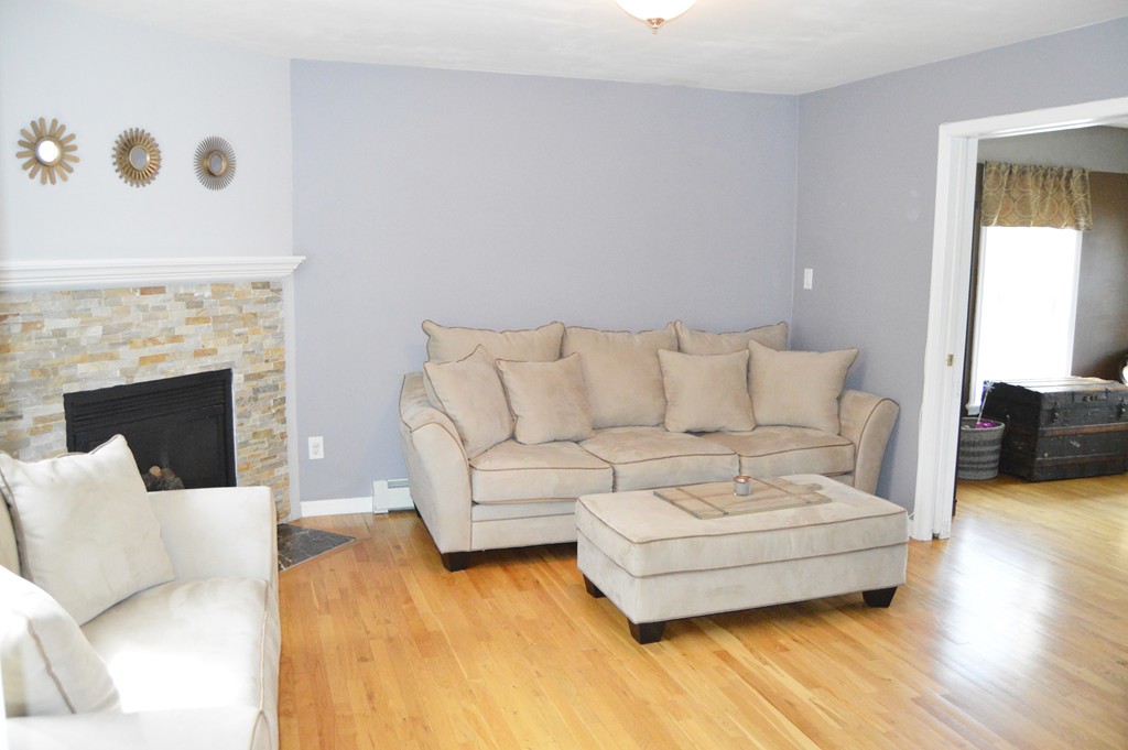 19 Birch Road Cumberland, RI 02864 - Photo 6 of 24 a living room with furniture and a fireplace