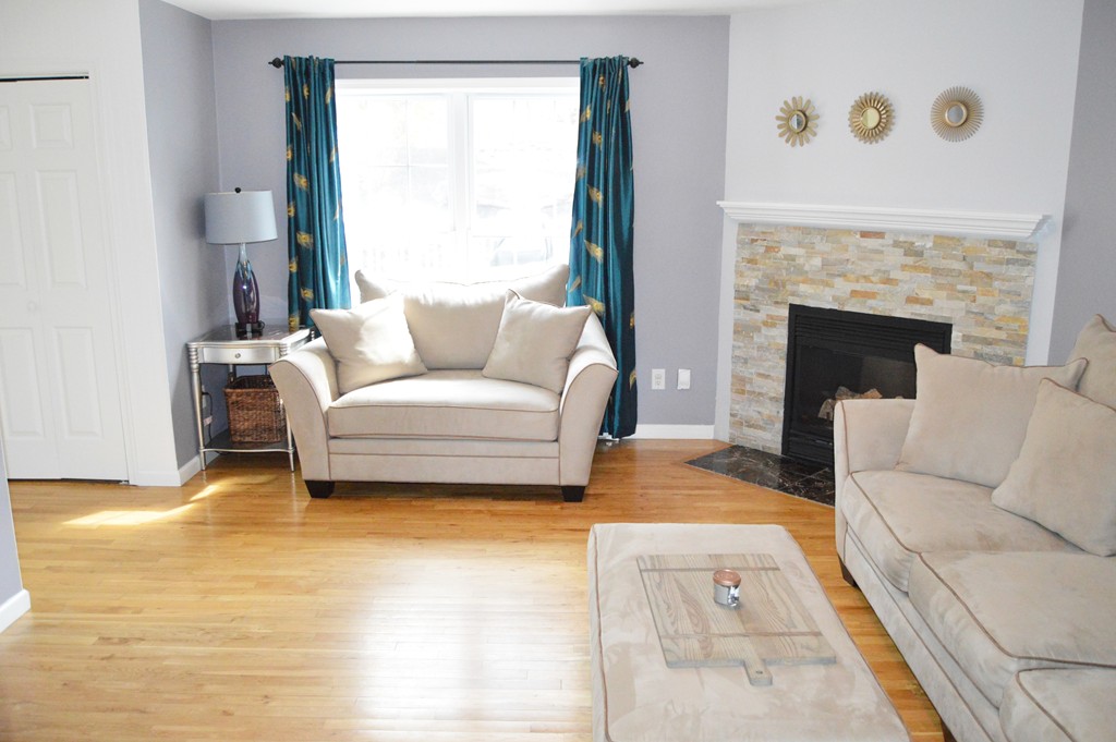 19 Birch Road Cumberland, RI 02864 - Photo 7 of 24 a living room with furniture and a fireplace