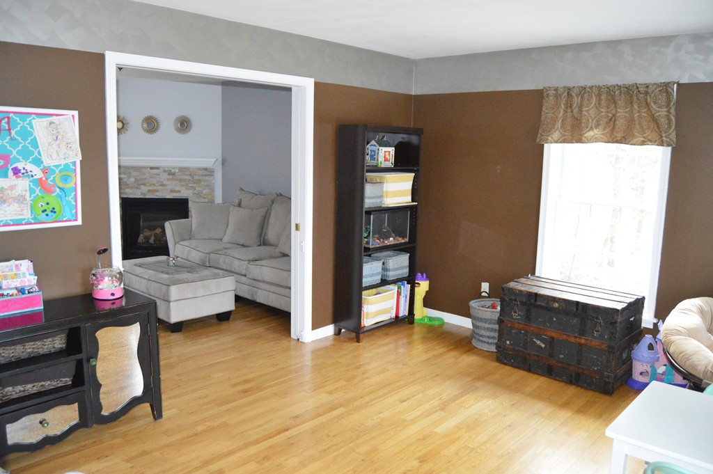 19 Birch Road Cumberland, RI 02864 - Photo 10 of 24 a living room with furniture and a fireplace