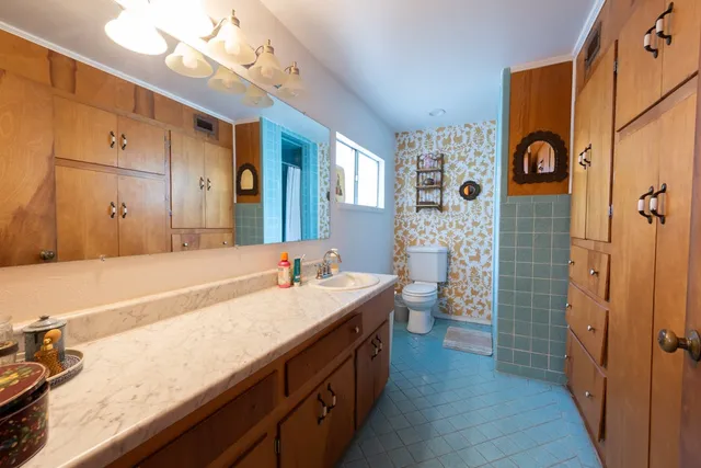 a bedroom with furniture and a window