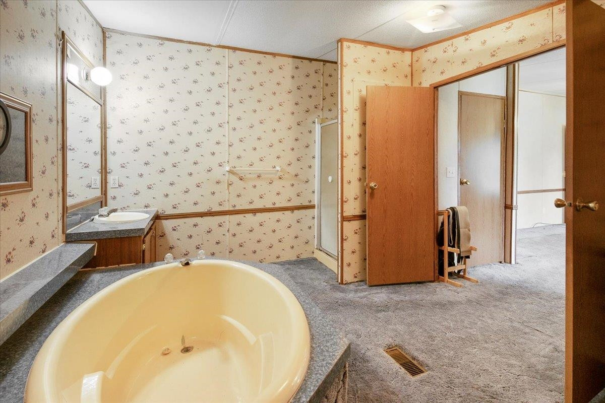 2014 Chad Place Angier, NC 27501 - Photo 20 of 47 a bathroom with a tub and shower