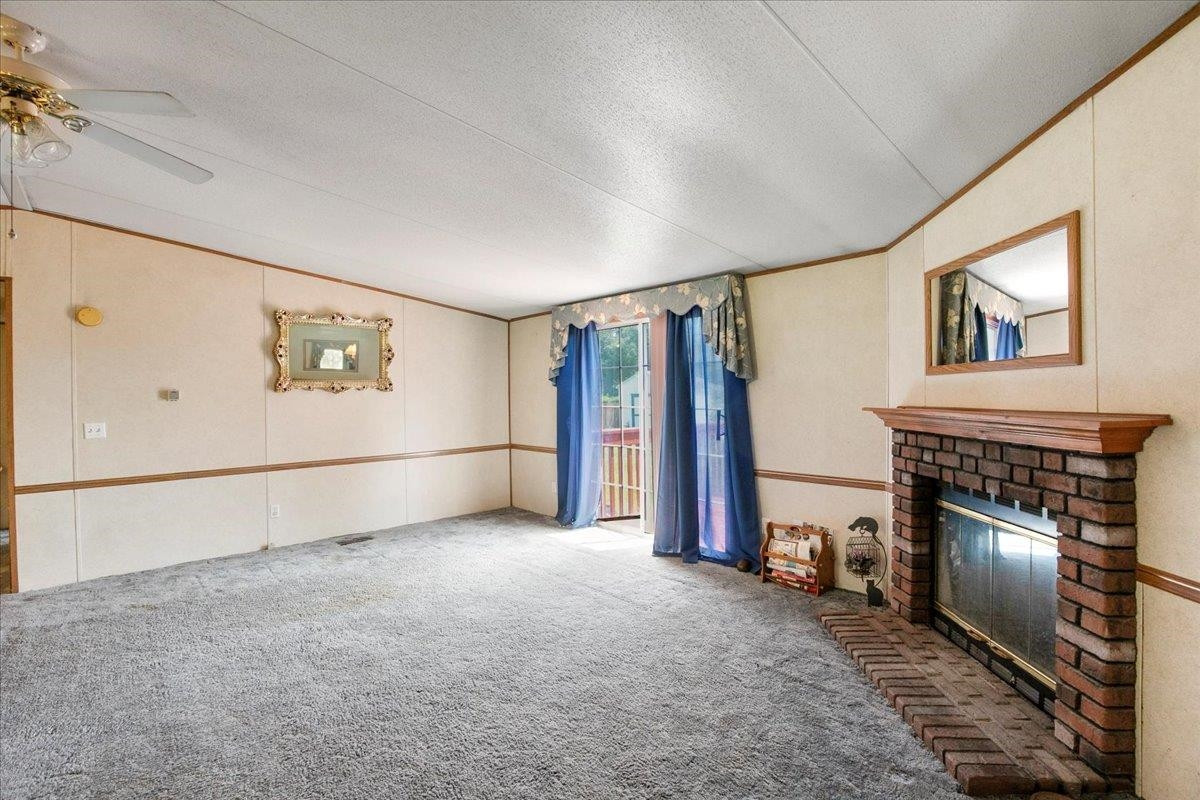 2014 Chad Place Angier, NC 27501 - Photo 7 of 47 a view of empty room with fireplace and window