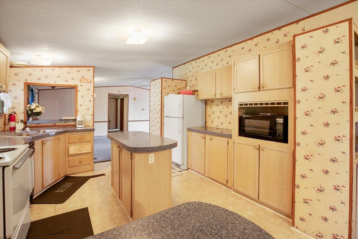 2014 Chad Place Angier, NC 27501 - Photo 10 of 47 a kitchen with stainless steel appliances a stove a sink and a refrigerator