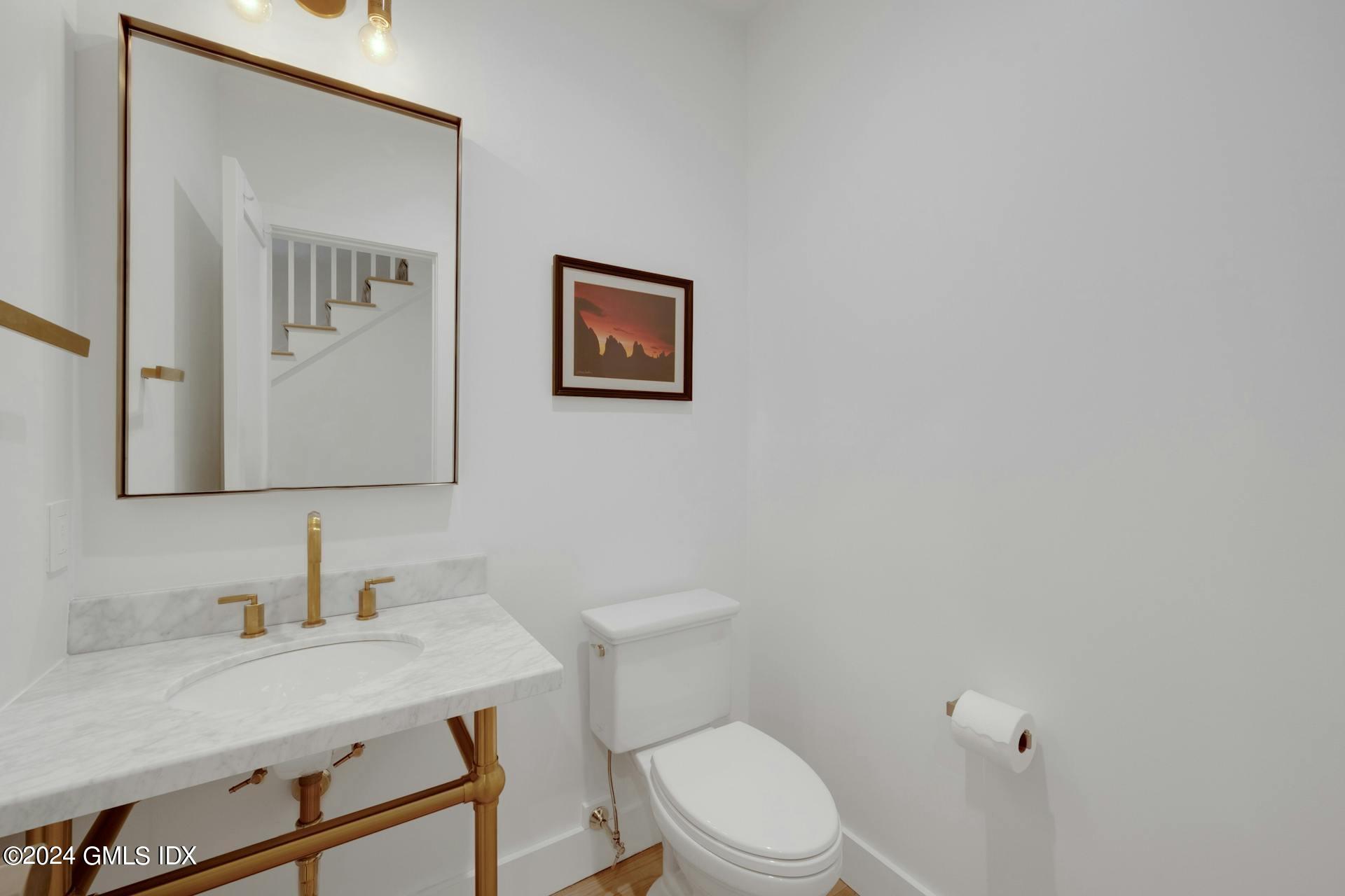 26 Chapel Lane Riverside, CT 06878 - Photo 15 of 35 a bathroom with a toilet a sink and mirror