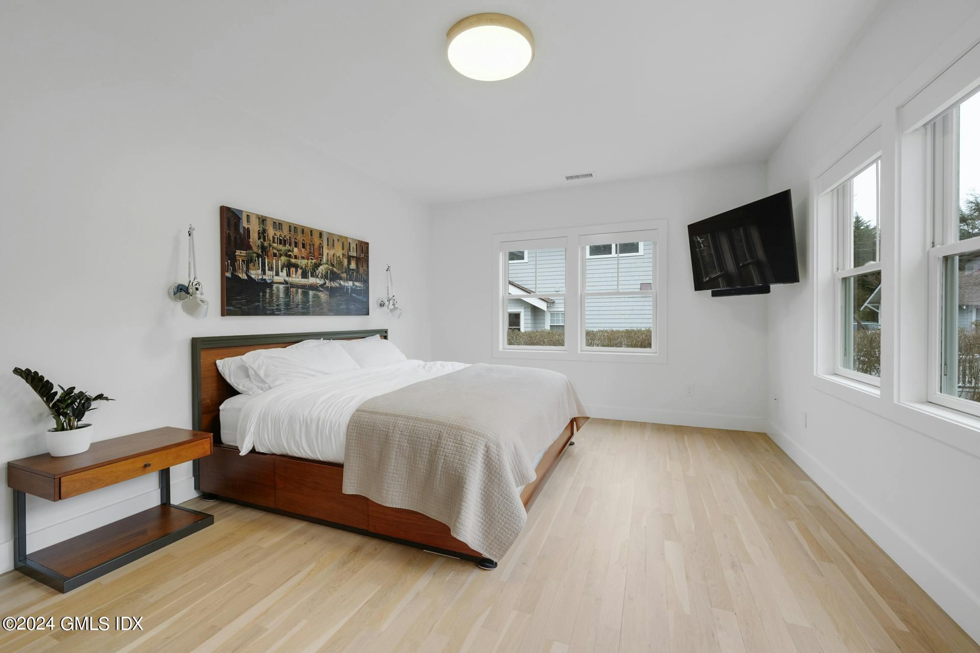 26 Chapel Lane Riverside, CT 06878 - Photo 16 of 35 a bedroom with a bed and a flat screen tv