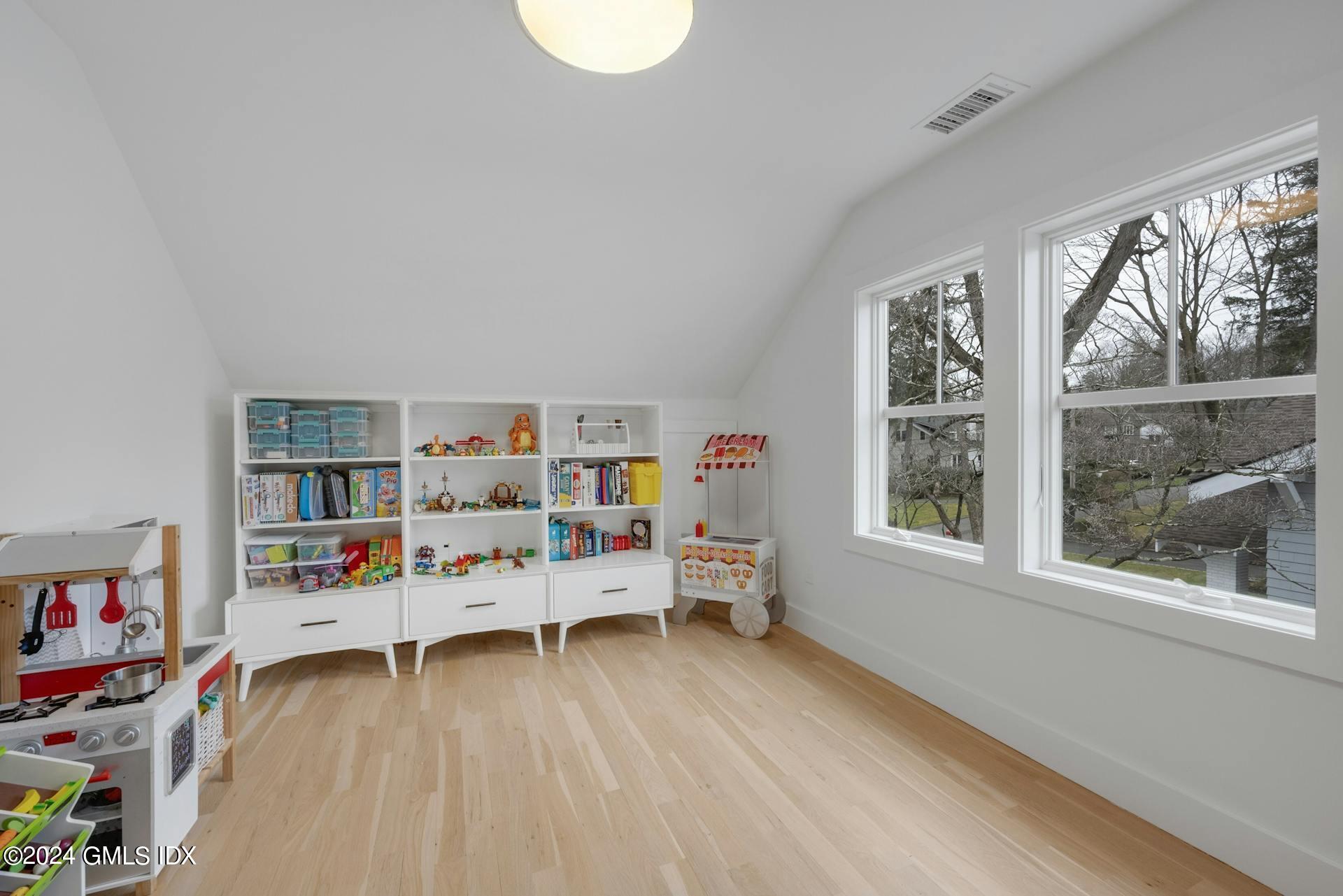 26 Chapel Lane Riverside, CT 06878 - Photo 30 of 35 a bedroom with furniture and a wooden floor