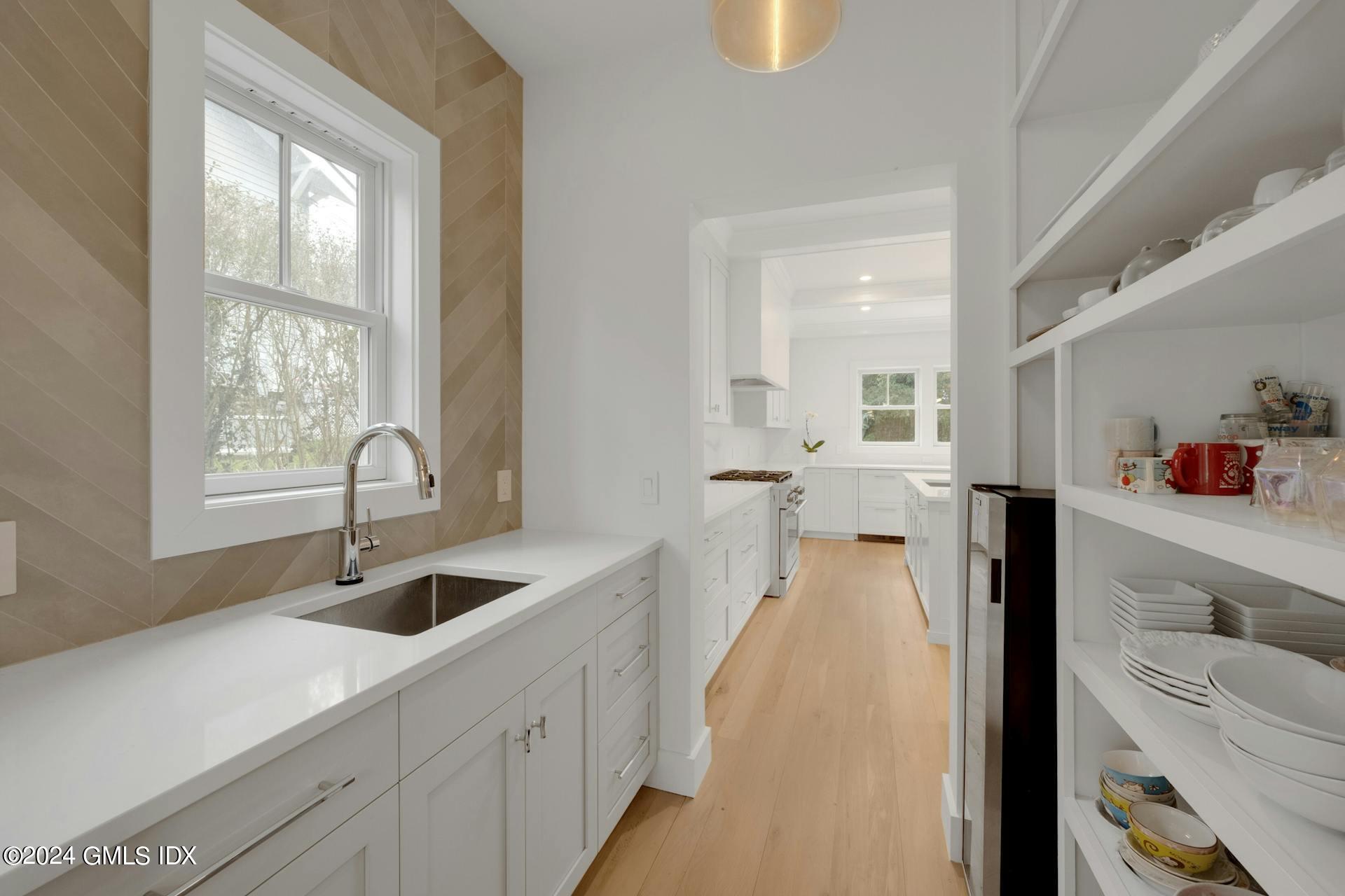 26 Chapel Lane Riverside, CT 06878 - Photo 8 of 35 a view of a kitchen with a sink and large window