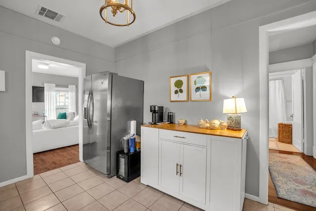 a kitchen that has a refrigerator and cabinets