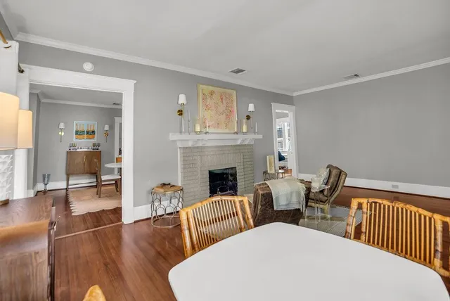 a living room with couches chairs and a fireplace